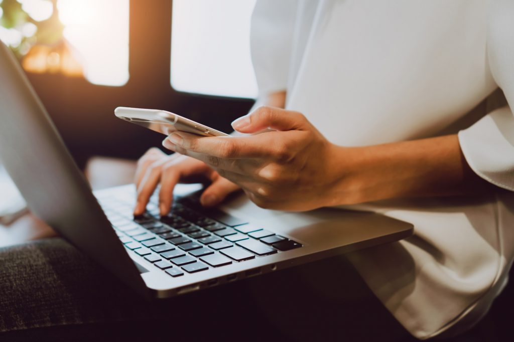 woman on computer and mobile device