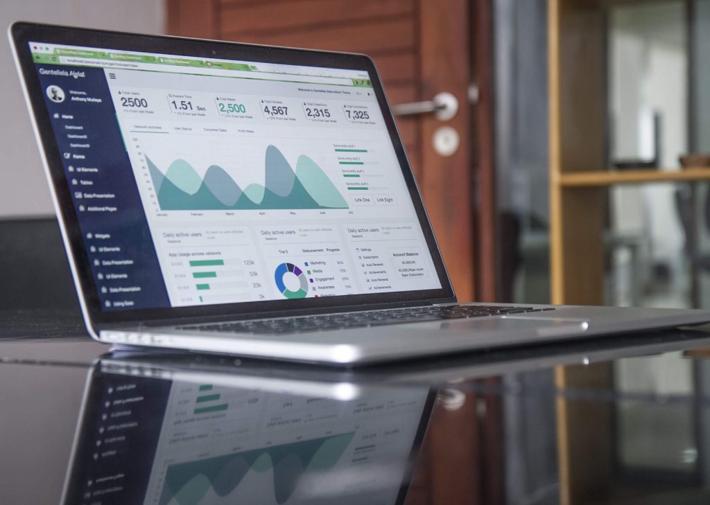 laptop on table showing analytics of marketing efforts