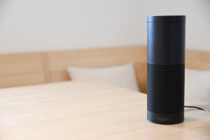a black Amazon Alexa on a wood table