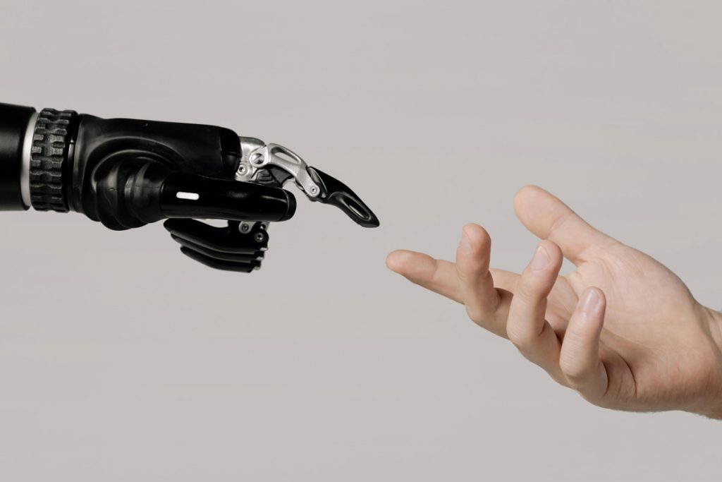 robotic hand reaching for human hand
