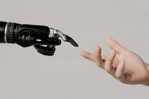 robotic hand reaching for human hand